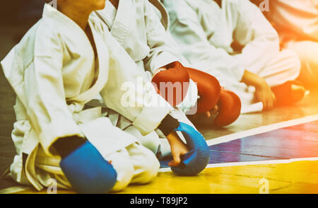 Concept karate, martial arts. participants sit in anticipation of fights. Leadership, responsibility, willingness to act, determination. Special Stock Photo