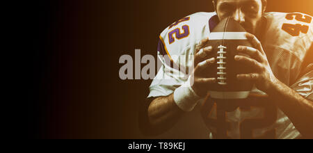Portrait close-up, American football player, bearded without a helmet with the ball in his hands. Concept American football, patriotism, close-up. Stock Photo