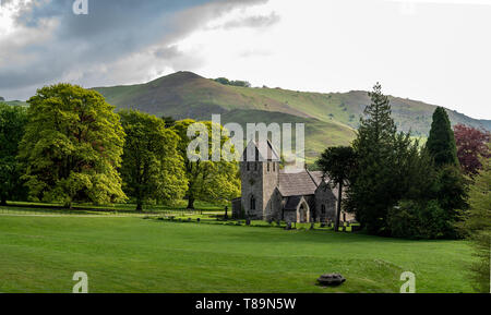 Church of the Holy Cross, Ilam, Peak District, Staffordshire, UK with Thorpe Cloud hill behind it Stock Photo