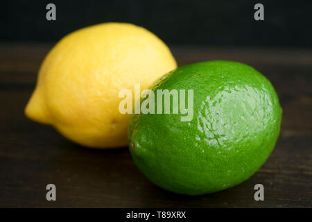 Lime and Lemon  on a Dark Wood Background Stock Photo