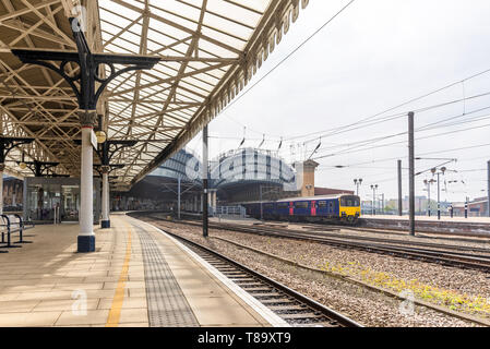 Northern end of York Railway station where two19th Century canopies of iron and glass sit astride the platforms.  An ornate canopy is in the foregroun Stock Photo