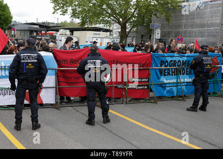Pforzheim, Germany. 11th May 2019. Police officers watch the counter protest. Around 80 people participated in a march through Pforzheim, organised by the right-wing party ‘Die Rechte’ (The Right). The main issues of the march was the promotion of voting for Die Rechte’ in the upcoming European Election and their anti-immigration policies. They were confronted by several hundred counter-protesters from different political organisations. Stock Photo