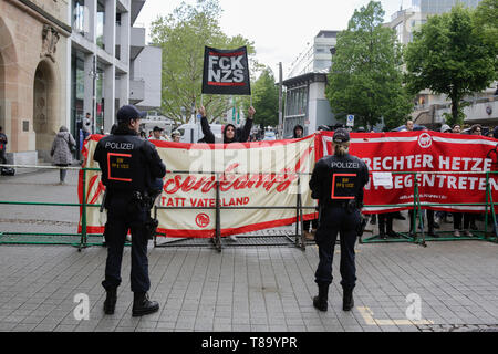 Pforzheim, Germany. 11th May 2019. Police officers watch the counter protest. Around 80 people participated in a march through Pforzheim, organised by the right-wing party ‘Die Rechte’ (The Right). The main issues of the march was the promotion of voting for Die Rechte’ in the upcoming European Election and their anti-immigration policies. They were confronted by several hundred counter-protesters from different political organisations. Stock Photo