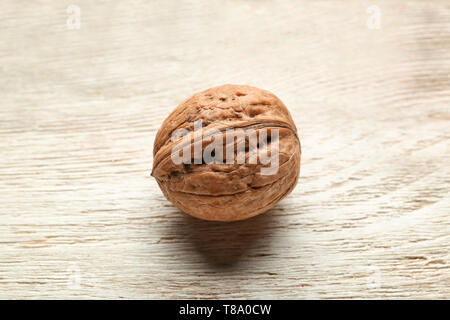 Unpeeled walnut on wooden background Stock Photo