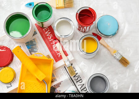 Paint cans with tools on table, top view Stock Photo