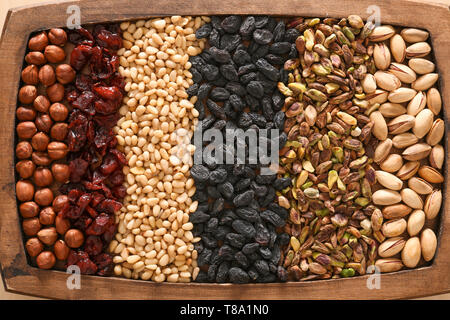 Various nuts and dried fruits on wooden tray Stock Photo