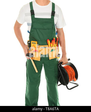 Electrician with extension cord reel on white background Stock Photo