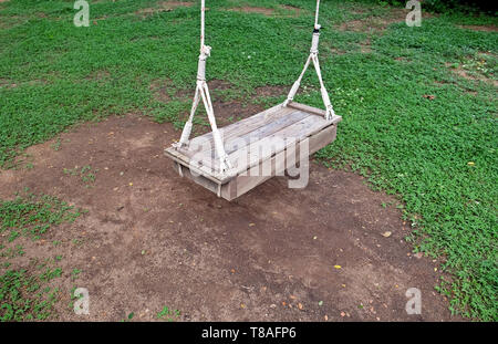 Hanging rope chair swing hanging with in the garden. When you want to relax you can sit on and swing you must be comfortable. Stock Photo