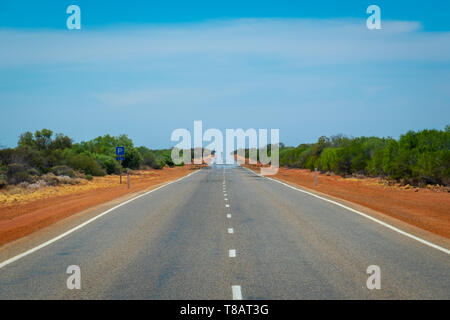 Mirage on an endless straight road leading through Australian Bush Stock Photo