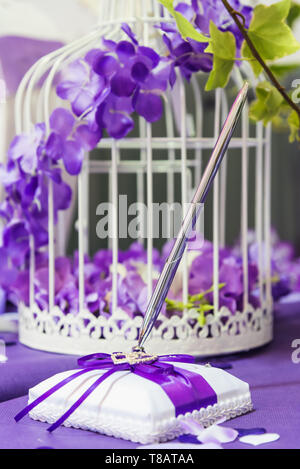 Guestbook and his pen on the day of a wedding sitting on the welcome table Stock Photo