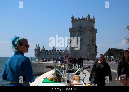 Young woman entrepreneur selling fresh squeezed orange juice to tourists at outside Belem Tower Belem, Lisbon Portugal Europe EU  KATHY DEWITT Stock Photo