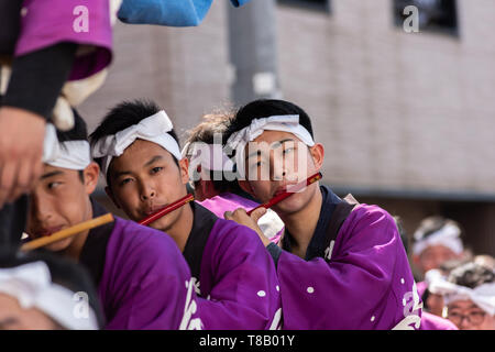 Karatsu, Japan - may 5, 2019 : young men in traditional costumes playing the flute during the parade to celebrate new imperial era 'reiwa' Stock Photo