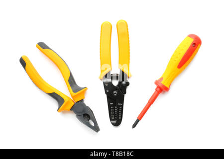 Pliers, wire stripper and screwdriver on white background Stock Photo