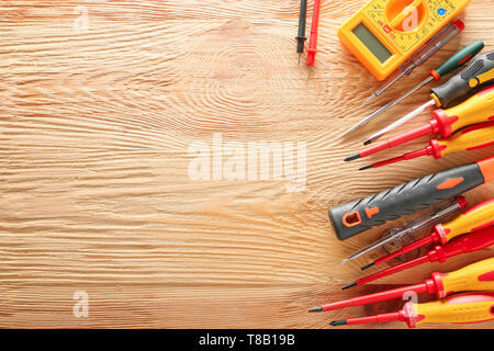 Different electrician's tools on wooden background Stock Photo