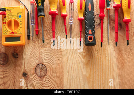 Different electrician's tools on wooden background Stock Photo