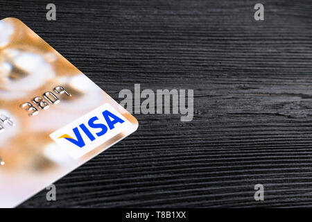 Sankt-Petersburg, Russia, July 09, 2017: Visa credit cards on office black desk board. close up view of a visa credit card on black wooden table. Phot Stock Photo