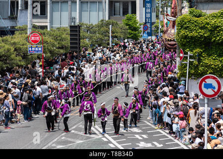 Karatsu, Japan - may 5, 2019 : people in traditional costumes drawning massive float through the street during new imperial era 'reiwa' celebration pa Stock Photo