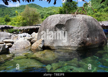 Elephant Spring - Beautiful crystal clear water spring for swimming with rocks and mountain in Suoi Voi Hue Vietnam famous beach vacation spot tourism Stock Photo