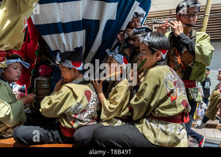 Karatsu, Japan - may 5, 2019 : young men in traditional costume playing the flute during the parade to celebrate new imperial era 'reiwa' Stock Photo