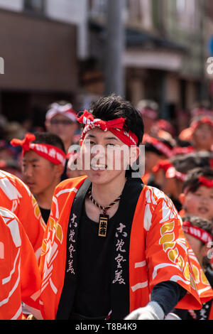 Karatsu, Japan - may 5, 2019 : young man in traditional costumes parade through the street drawning massive floats to celebrate new imperial era 'reiw Stock Photo