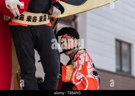 Karatsu, Japan - may 5, 2019 : young man in traditional costume playing the flute during the parade to celebrate new imperial era 'reiwa' Stock Photo