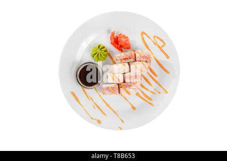 Sushi, rolls, uramaki with bacon, cucumber, cheese, meat and teriyaki sauce, marinated ginger and wasabi, white isolated background, view from above Stock Photo