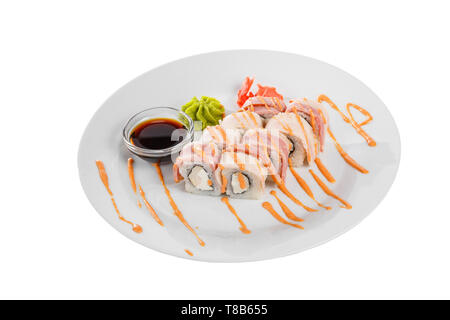 Sushi, rolls, uramaki with bacon, cucumber, cheese, meat and teriyaki sauce, marinated ginger and wasabi, white isolated background, side view Stock Photo