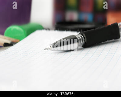 close up.ballpoint pen Notepad on blurred background. Stock Photo