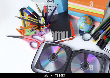 stack of CDs and school supplies isolated on white background.photo with copy space. Stock Photo