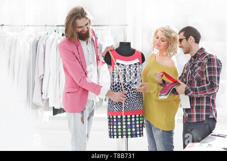 designers discussing new fabric colors in creative Studio. Stock Photo