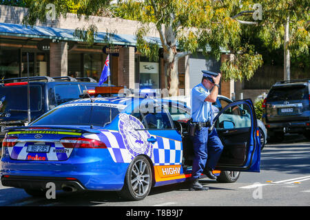 Australian police officer in Highway Patrol police car at an ANZAC Day march in Sydney,NSW, Australia Stock Photo