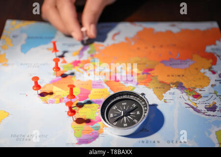 Modern compass with pushpins on world map Stock Photo
