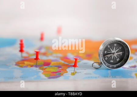 Modern compass with pushpins on world map Stock Photo