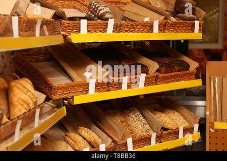 Assorted fresh tasty bread in shop Stock Photo