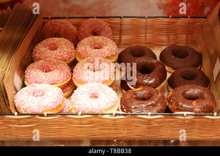 Fresh tasty doughnuts in wicker basket Stock Photo