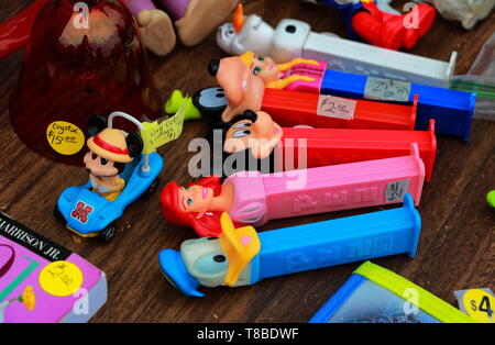 vintage PEZ containers and other colorful toys on sale at flea market Stock Photo