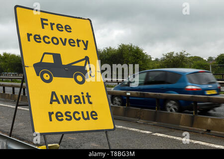 Free recovery await rescue sign on the side of the M6 motorway in the roadworks Stock Photo