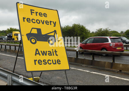 Free recovery await rescue sign on the side of the M6 motorway in the roadworks Stock Photo