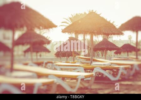 Beach umbrellas on the the beautiful beach in Morocco. Selective focus. Stock Photo