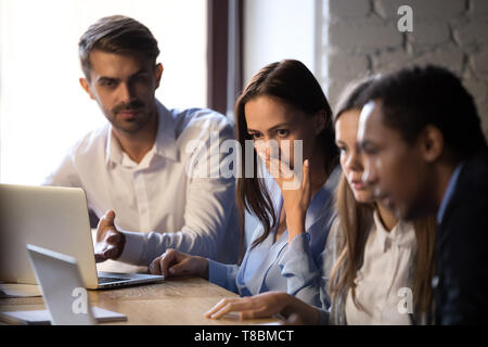 Surprised baffled diverse colleagues received bad news by email Stock Photo