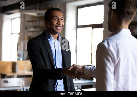 Boss shaking hands greeting new employee or company client Stock Photo