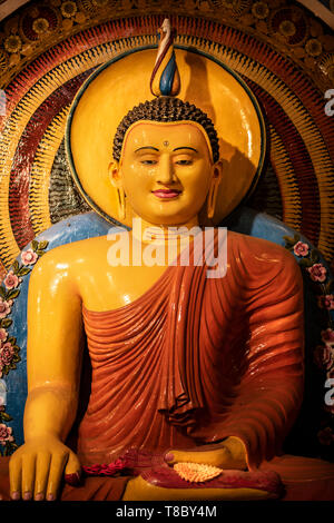 One of the ornate and colourful Buddha statues at the Gangaramaya Temple in Sri Janaratana Road in the Sri Lankan capital of Colombo. Stock Photo