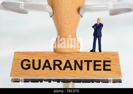 Guarantee printed on rubber stamp Stock Photo