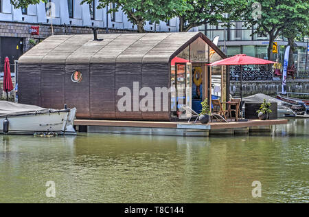 Rotterdam, The Netherlands, June 18, 2017: tiny house with wooden facades and roof on a floating platform in Wijnhaven harbour Stock Photo