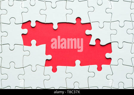 Jigsaw puzzle game piece on red background for business theme design Stock Photo