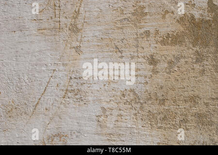 old obsolete beige color plastered wall background texture Stock Photo