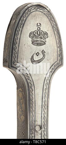 A silver-mounted Caucasian kinjal, circa 1900 The blade fullered on both sides, slightly notched edge, nielloed and part-gilt silver grip with fine engravings on the obverse. The back of the pommel engraved with an Egyptian crown surmounting the Arabic letter 'B'. Wood scabbard with mounts nielloed and gilt en suite, short leather insert at back. The pommel slightly burst. Length 50 cm. Probably a gift to an Egyptian prince. historic, historical, Ottoman, Orient, Oriental, Asia, Asian, 20th century, Additional-Rights-Clearance-Info-Not-Available Stock Photo