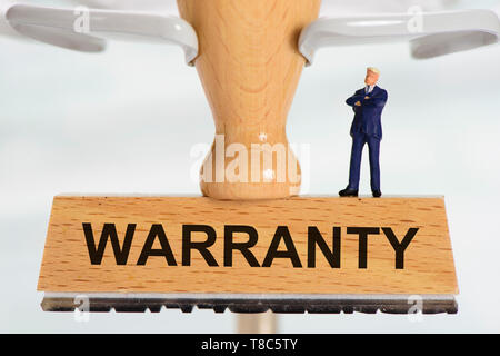 Warranty printed on rubber stamp Stock Photo