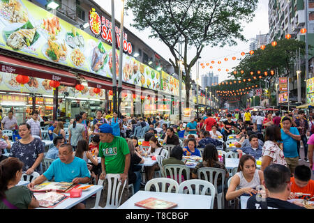 Outdoor food restaurants on crowded street Jalan Alor located in Bukit Bintang, Kuala Lumpur, Malaysia
