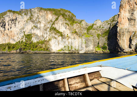 (Selective focus) Stunning view of some limestone rock mountains surrounding the beautiful Maya Bay. Photo taken from a traditional long tail boat.